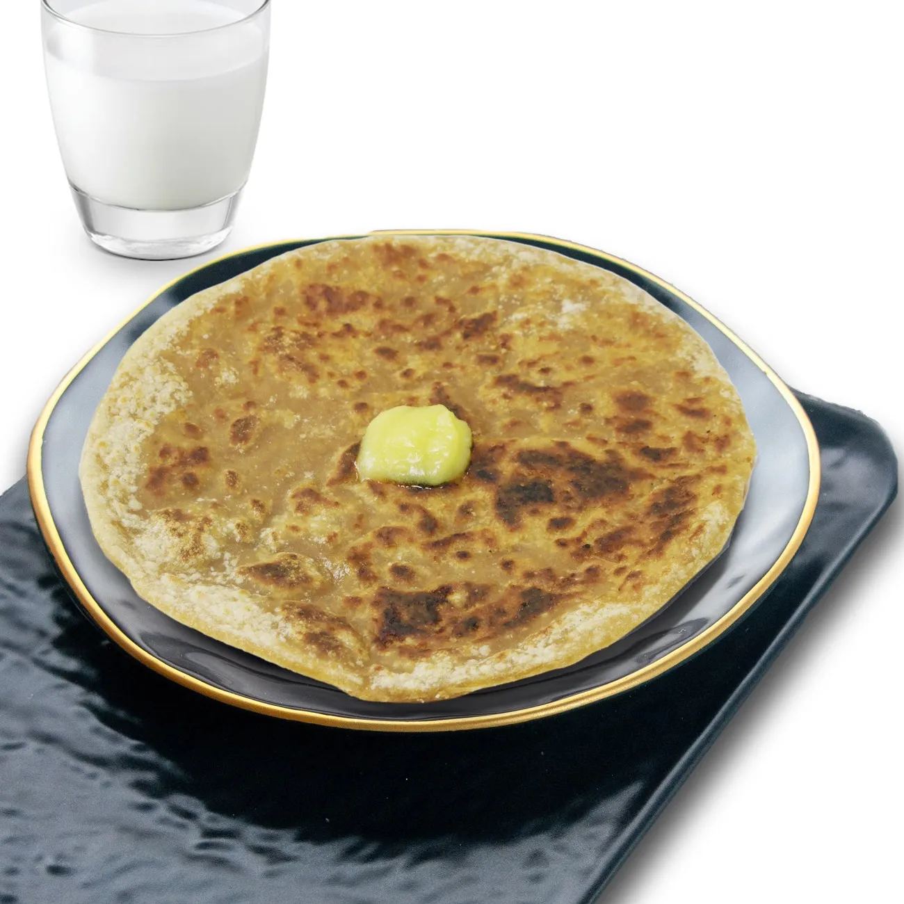 Puran poli, a sweet stuffed flatbread, served with a dollop of ghee